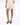 Light beige shorts paired with a matching top, complemented by black open-toe heels.