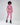 A model poses in a pink cropped sweatshirt and matching joggers, paired with black platform boots.