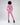 A model wearing a pink cropped top and matching joggers, paired with black heeled boots, viewed from behind.