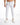 White jeans with ribbed detailing, paired with white sneakers, worn by a model.