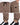 Lightweight brown pants with an elastic waistband, side pockets, and cuffed ankles, paired with black and white sneak...