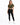 A woman stands wearing a cropped olive green top tied at the waist, paired with black leggings and white sneakers.