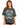A woman models a relaxed-fit, dark gray t-shirt featuring a colorful graphic design with "New York" and decorative el...
