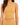 A model wearing a ribbed, one-shoulder, mustard-colored crop top paired with a matching bottom.
