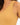 Close-up of a ribbed, mustard-colored tank top featuring a wide neckline and thin straps.