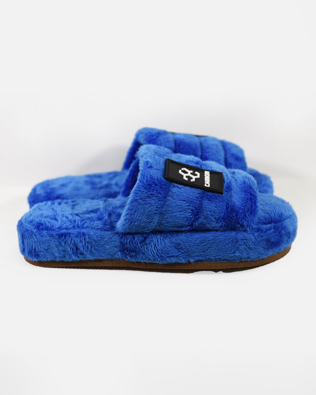 Carbon brand blue fuzzy fluffy slippers with cloud- straps, and rubber soles.
