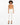 Model wearing a fitted, tan bodysuit paired with white tailored pants and black strappy heels.