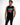 A man wearing a black sleeveless shirt with colorful "GAME OVER" graphic and distressed black jeans.