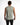 A man is shown from the back wearing a sleeveless, light green top paired with dark jeans.