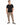 A man stands confidently in a black t-shirt and beige cargo pants with zippered pockets, paired with stylish sneakers.