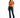 A woman stands confidently in a tied, rust-colored top and dark flared jeans, paired with black heels.