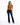 A woman stands confidently in a cropped, rust-colored top and dark flared jeans, paired with black heels.