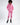 Model wearing a pink long-sleeve Gem Romper with drawstring waist and zip-up collar, paired with black platform boots.