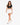 A model walks confidently in a black cropped top and white shorts, paired with white sneakers.