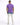 A person wearing a purple t-shirt and light-colored jeans with a blue tie-dye pattern, viewed from behind.