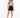 A model with curly hair wears a patterned tank top and high-waisted black shorts, paired with black sneakers.