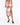 A model wearing a colorful floral print skirt with a thigh-high slit, paired with black heeled mules.