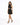 A woman poses in a black sparkly dress with a halter neck and cut-out details, paired with strappy heels.