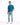 A man stands confidently in light blue distressed jeans, paired with a teal t-shirt and white sneakers.