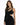A model showcases a fitted black dress with a unique asymmetrical design and cut-out details.