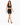 A model walks confidently in a black cropped top and matching skirt with lace-up details and a bow tie.