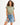 Model in Gravity Grey Padded Muscle Tee with structured shoulders and distressed denim shorts against white background.