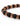 Close-up of a bracelet featuring matte black beads interspersed with shiny copper rings, showcasing a modern design.