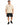 A man stands wearing a beige oversized t-shirt with a graphic design, paired with black shorts and sneakers.