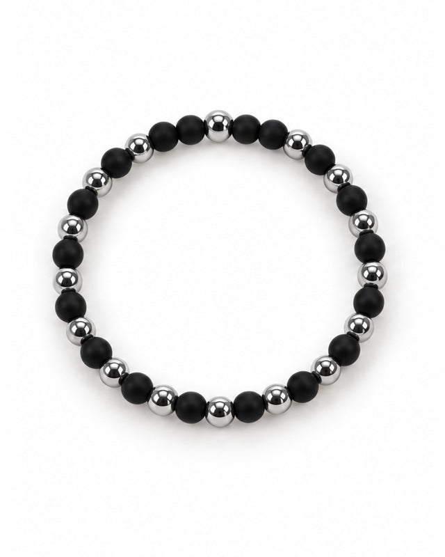 A circular bracelet featuring alternating matte black and shiny silver beads for a modern, stylish look.