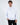 Men's white oversized streetwear hoodie with 'enlightened' text, featuring a front pocket and on model.