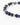 A close-up of a beaded bracelet featuring deep blue stones and gold geometric accents.