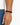 A close-up of a hand wearing a black braided bracelet with a sleek metal clasp, showcasing a minimalist design.
