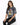 A woman sits wearing a gray tie-dye t-shirt featuring a colorful tiger graphic, paired with black jeans.