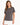 Woman wearing a gray short-sleeve tee with a stylish graphic design on the front, paired with a white skirt.