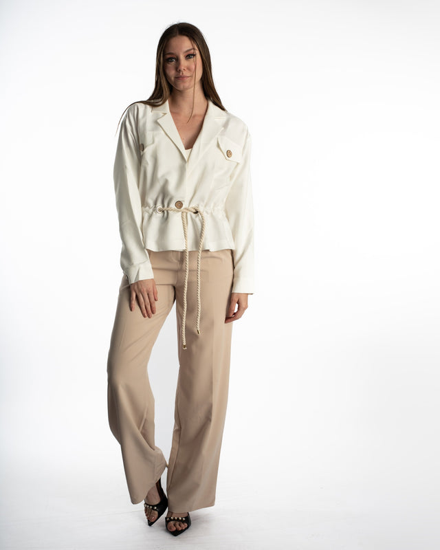 Model wearing Rhea White Denim Jacket with utility pockets, wooden buttons, and a cinched rope belt waist streetwear style.