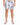 Men's swim shorts featuring a floral pattern in black and white, paired with casual slide sandals.