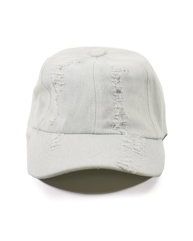 Distressed light wash denim baseball cap with heavy ripped texture and streetwear vibe on white background.