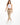 A woman walks confidently in beige pants paired with a white crop top and white sneakers, showcasing a casual style.