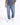 A person wearing light blue distressed jeans and white sneakers, standing casually.