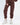 Close-up of JOLENE burgundy two-piece jogger pants set with elastic cuffs and white sneakers for women's streetwear.