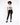 A model poses in a white graphic t-shirt and black skinny jeans, paired with black sneakers.