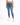 A person wearing a white cropped top and blue high-waisted skinny jeans, paired with white sneakers.