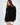 Model wearing the Celine black oversized turtleneck knit sweater with a distressed fringe hem.