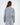 Back view of a woman wearing an oversized light grey Sailing Top sweatshirt with a modern streetwear fit.