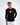 Model wearing Keep On Moving black long sleeve streetwear graphic tee with yellow chest print and white jeans.