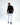Back view of the black Keep On Moving graphic long sleeve streetwear shirt on a male model with white jeans.
