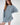 Model wearing Saylor blue oversized distressed cable knit sweater with for a Gen Z aesthetic.