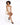 A model with curly hair poses on a stool, wearing a light-colored dress and black open-toe heels.