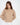Serena off-white cable knit sweater, ribbed turtleneck, and drop shoulders on a female model.