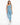 A woman poses in an one-shoulder top and matching leggings, showcasing a blue color and sporty style.